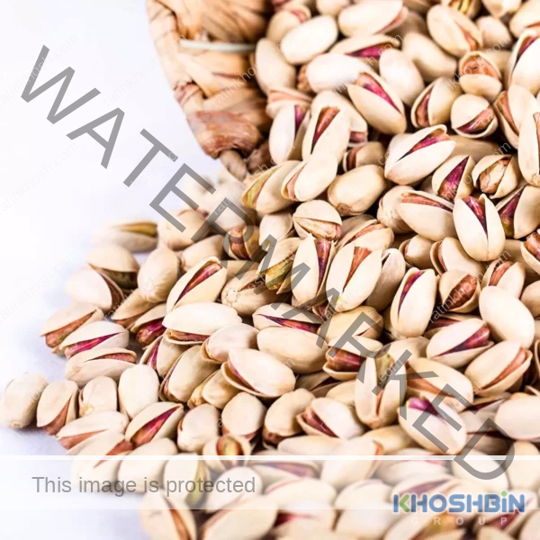 A mass of Akbari pistachios poured from a bowl