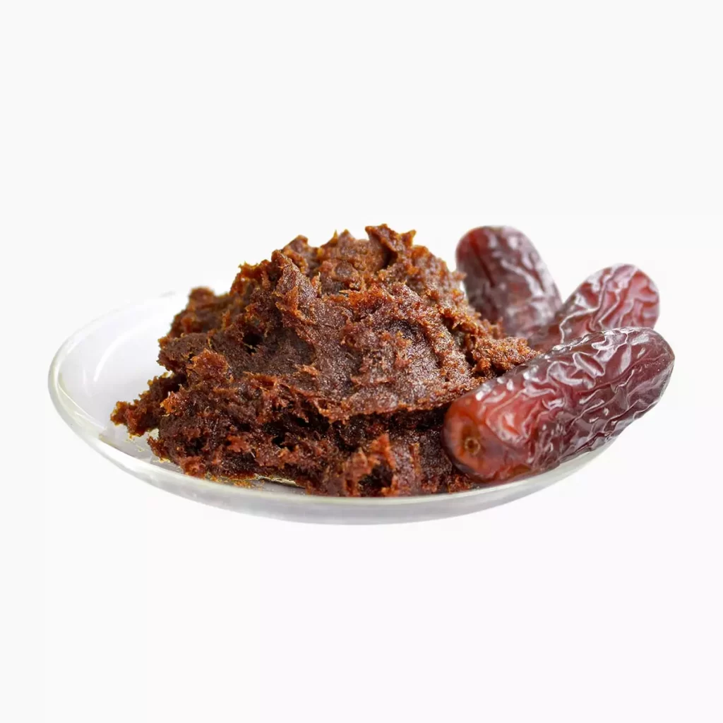 Some date paste and two date fruits on a plate