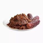 Some date paste and two date fruits on a plate