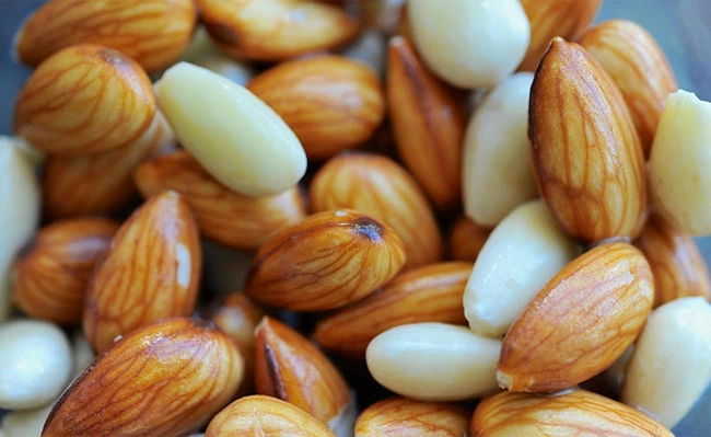 The picture shows blanched Almonds (white color) and unblanched Almonds (brown color)