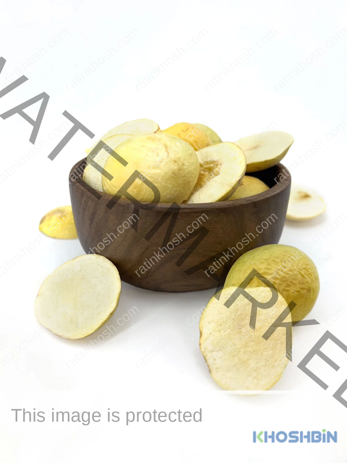 some slices of freeze dried apricot from front and rear view next to a bowl full of freeze dried apricot slices