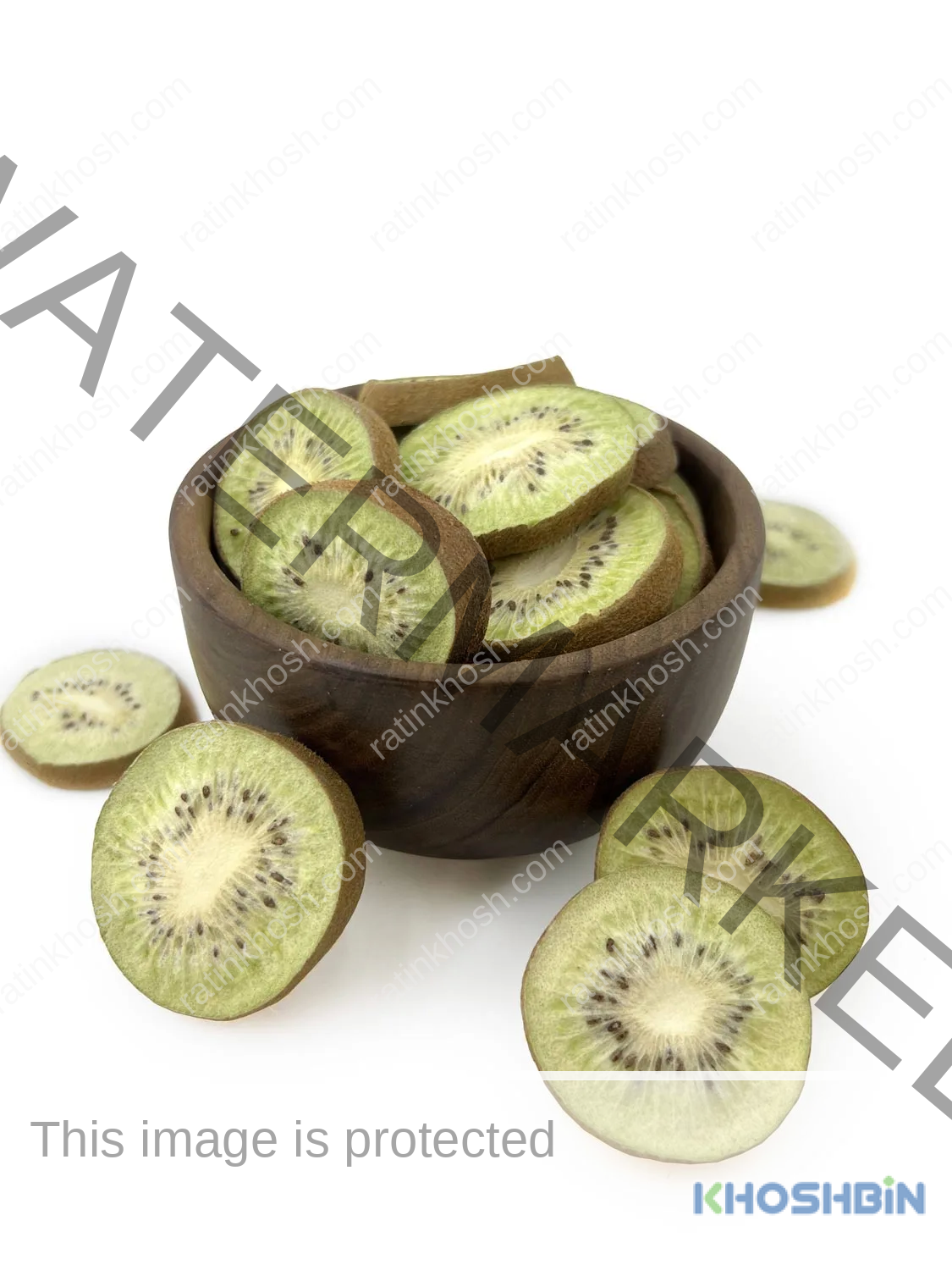 some slices of freeze dried kiwi from from front view, and a bowl full of freeze dried kiwi slices, a few kiwi slices around it