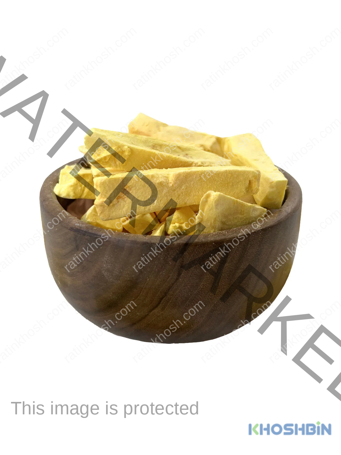 Three long pieces of freeze dried mango, a bowl full of freeze dried mango