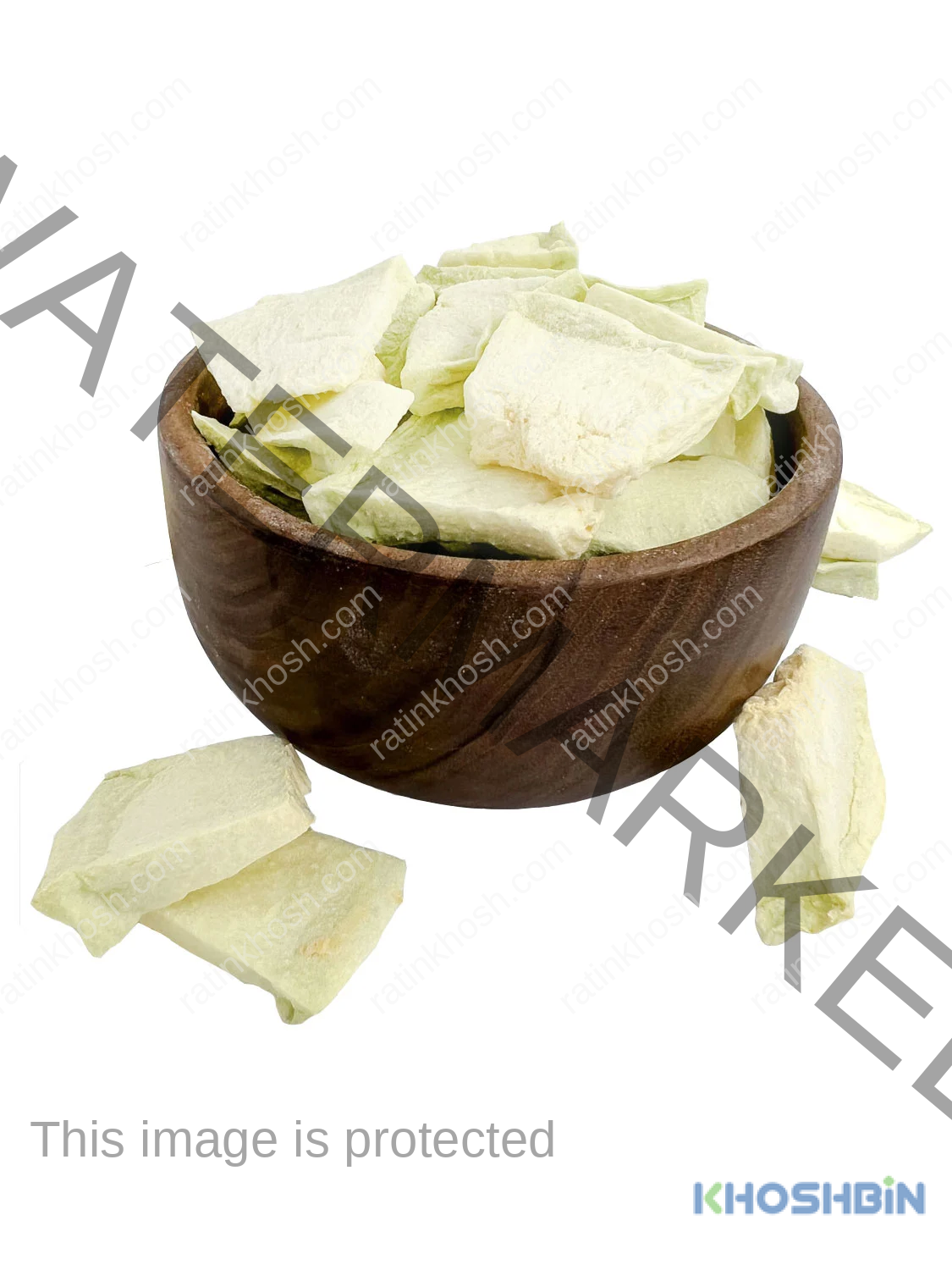 Three small pieces of freeze dried melons, a bowl full of freeze dried melon chunks and few others around it