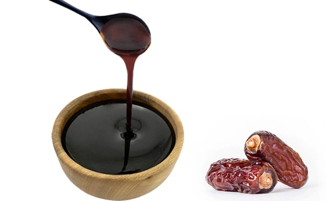 The picture shows date syrup pouring into a wooden bowl.