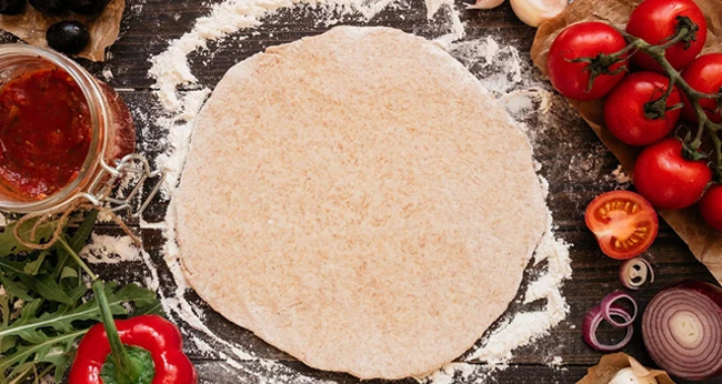 A pizza crust made of whole flour, date paste and other ingredients