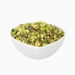 Pistachio granules in a heart-shaped bowl from a side view