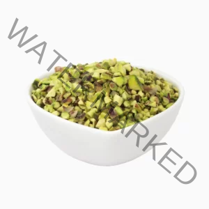 Pistachio granules in a heart-shaped bowl from a side view