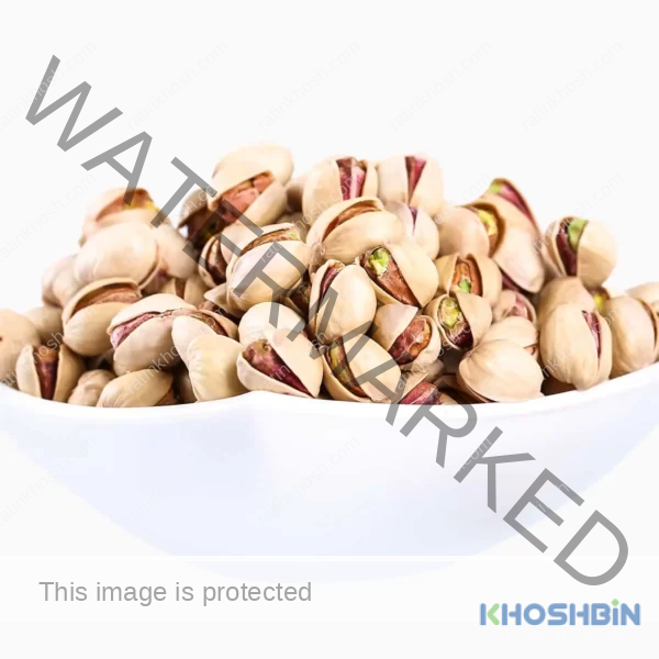 Side view of Fandoghi (round) pistachios in a bowl