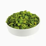 Green psitachio flakes (flaked pistachios) in a round bowl