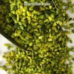 Green chopped pistachios (2-4 mm granules) in a bowl