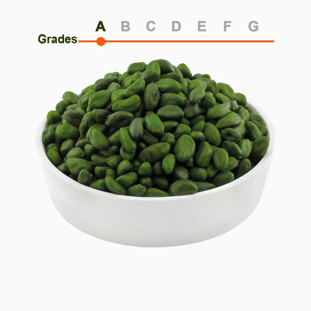 Green peeled pistachio kernels grade A in a wooden ball