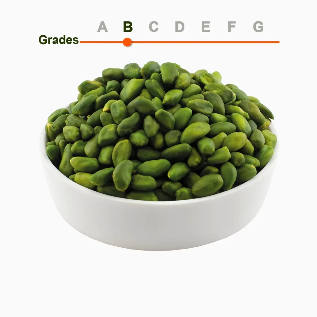 Green peeled pistachio kernels grade B in a wooden ball