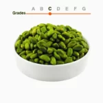 Green peeled pistachio kernels grade C in a wooden ball