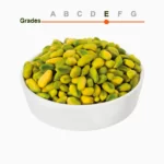 Green peeled pistachio kernels grade E in a wooden ball