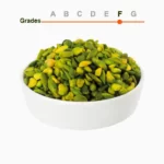 Green peeled pistachio kernels grade F in a wooden ball