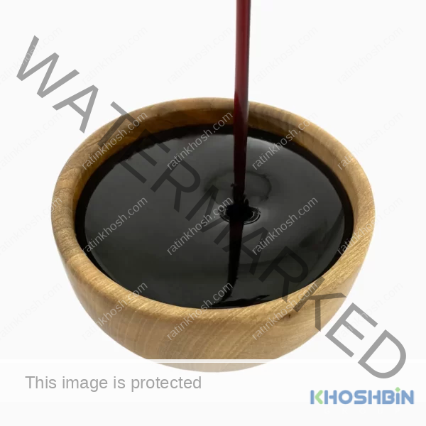 a wooden bowl filled with date syrup