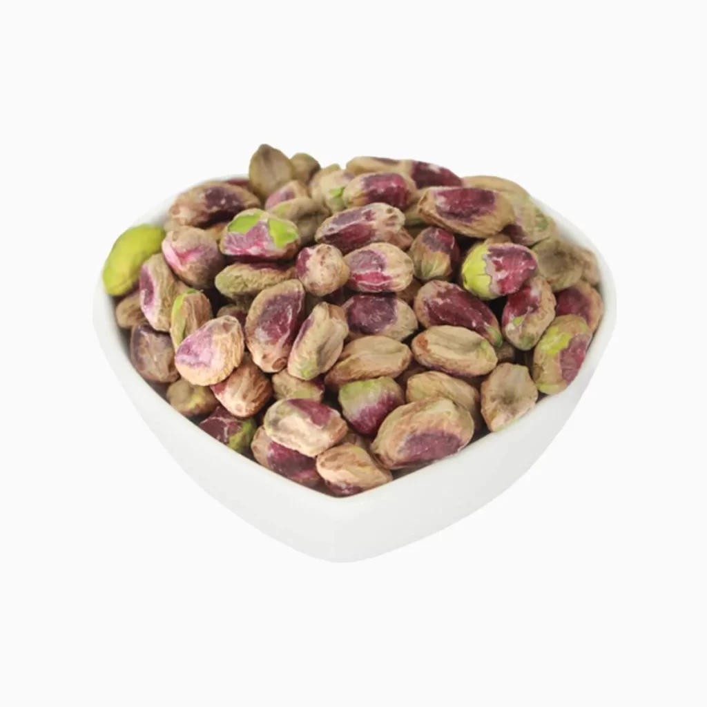 A top view of regular pistachio kernels in a bowl